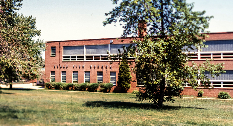 Color photograph of Belle View Elementary School from a 35 millimeter slide. The photograph shows the side of the building that faces Fort Hunt Road. The picture was taken in the late 1970s or early 1980s. 
