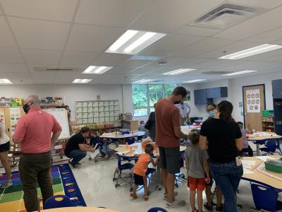 Families and students gather in a classroom